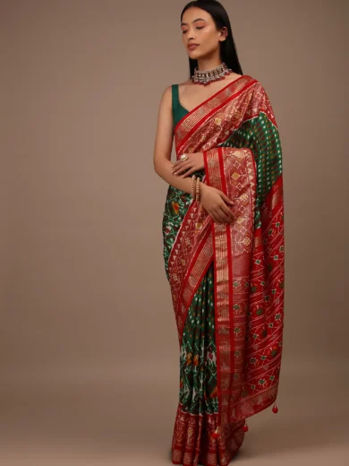 Bottle Green Saree In Silk With Multi Colored Patola And Foil Print And Contrasting Red Border